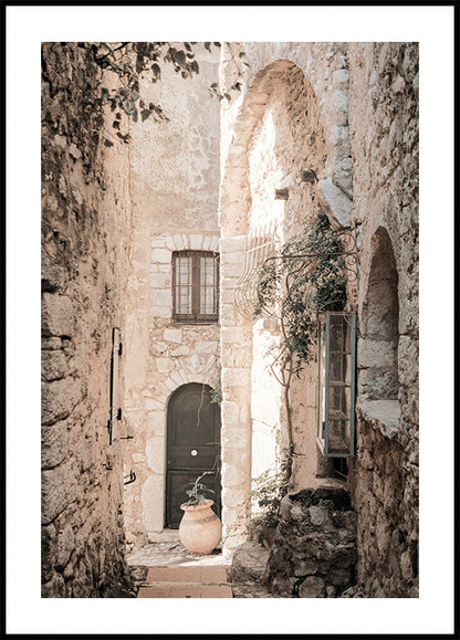 a narrow alley way with a potted plant on the side